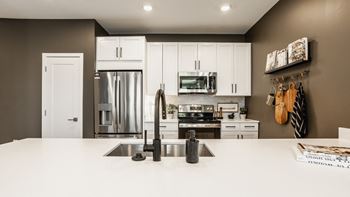 Modern Kitchen With Stainless Steel Appliances And Double Door Refrigerators at Nuvo Flats, Merrillville, IN, 46410